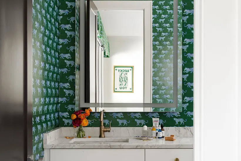 Green leopard parade wallpaper in home bathroom.