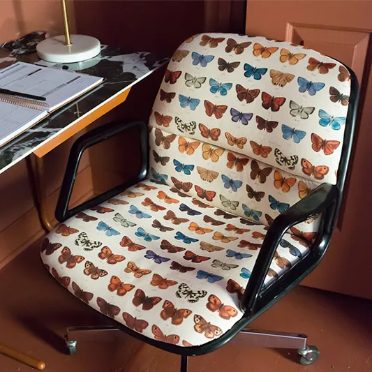 Office chair reupholstered with butterfly printed performance velvet fabric.