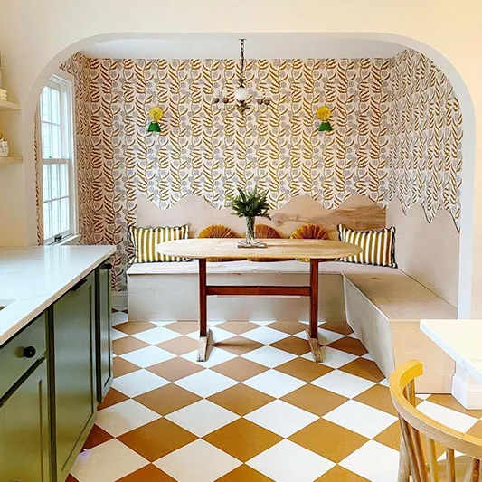 Gold vine wallpaper in a kitchen dining area.