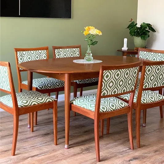 Mid-century table and reupholstered chairs with a retro pattern.